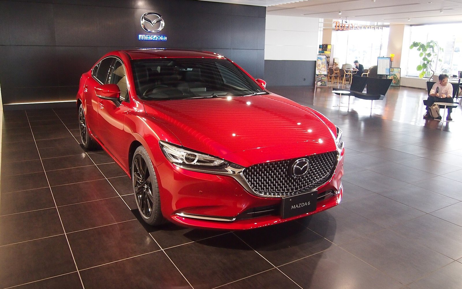 Mazda 6 Signature — Red Mazda 6 full-size sedan rental car in a showroom