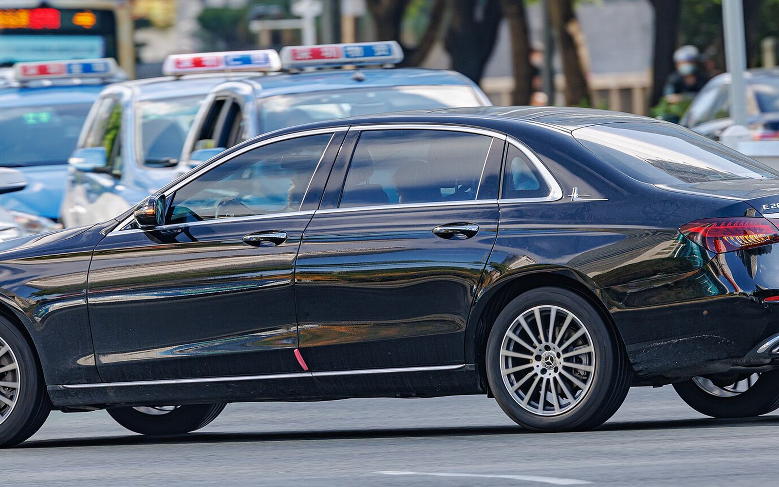 Mercedes-Benz E-Class — Dark Mercedes-Benz E-Class luxury sedan rental car, side view