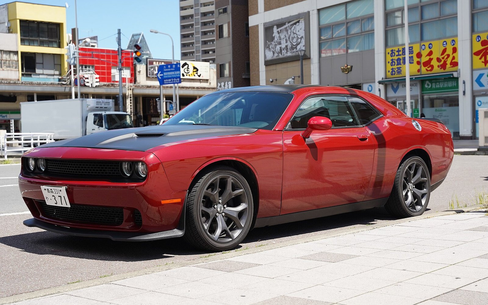 Dodge Challenger — Red Dodge Challenger muscle coupe rental car, front three-quarter view