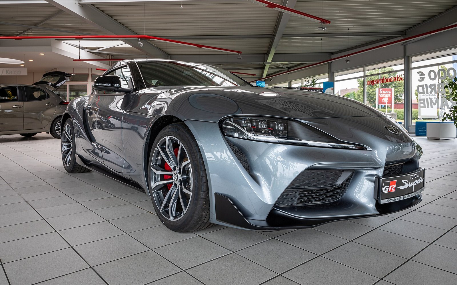 Toyota GR Supra — Silver Toyota GR Supra sports coupe rental car, front three-quarter view
